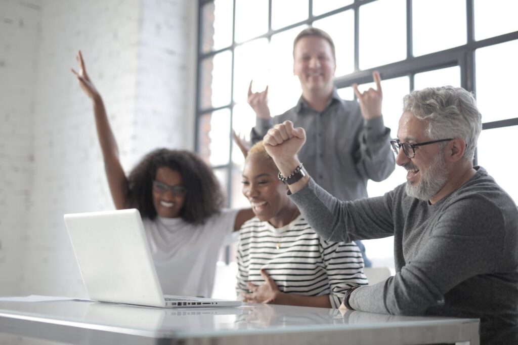 Group of employess chearing after seeing thier high performance work